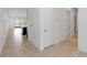 Hallway with tile floors transitioning to an open-concept layout, offering easy access to other rooms at 4918 Drawdy Ct, St Cloud, FL 34772