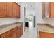 Walkway to kitchen featuring granite countertops, wooden cabinets, and stainless steel fridge at 4918 Drawdy Ct, St Cloud, FL 34772