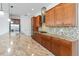 Gourmet kitchen showcasing granite countertops, tile backsplash, stainless appliances, and ample cabinet space at 4918 Drawdy Ct, St Cloud, FL 34772