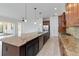 Bright kitchen featuring a spacious island with a sink, granite countertops, and a seamless flow to the living area at 4918 Drawdy Ct, St Cloud, FL 34772