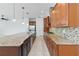 Open-concept kitchen with a large island, granite countertops, stainless steel appliances, and tile flooring at 4918 Drawdy Ct, St Cloud, FL 34772