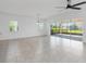 Spacious living room featuring sliding glass doors to backyard and a ceiling fan at 4918 Drawdy Ct, St Cloud, FL 34772