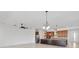 Open floor plan with kitchen featuring granite countertops, a stainless steel fridge, and modern appliances at 4918 Drawdy Ct, St Cloud, FL 34772