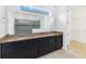 Main bathroom featuring a double sink vanity with granite countertop, large mirror, and glass door shower at 4918 Drawdy Ct, St Cloud, FL 34772