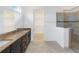 Main bathroom featuring a double sink vanity with granite countertop, glass door shower, and a walk-in closet at 4918 Drawdy Ct, St Cloud, FL 34772