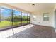 A covered and screened-in brick patio with views of the backyard and exterior windows at 4918 Drawdy Ct, St Cloud, FL 34772