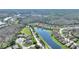 Scenic aerial view of homes along a lake, surrounded by lush green trees, in a serene community at 555 Presido Park Pl, Kissimmee, FL 34759