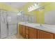 This is a full bathroom with a glass door shower and double sinks at 555 Presido Park Pl, Kissimmee, FL 34759
