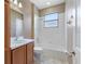 This is a full bathroom with tiled walls and floors and updated fixtures at 555 Presido Park Pl, Kissimmee, FL 34759