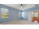 This bedroom has carpeted floors and two windows with a view at 555 Presido Park Pl, Kissimmee, FL 34759