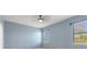 This bedroom has carpet, a ceiling fan, and a large window with a view at 555 Presido Park Pl, Kissimmee, FL 34759