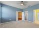 This is a bedroom with carpet and access to two other rooms at 555 Presido Park Pl, Kissimmee, FL 34759