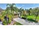 Well-maintained home with lush tropical landscaping, a paver driveway, and an attached two-car garage at 555 Presido Park Pl, Kissimmee, FL 34759
