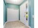 Bright foyer featuring tile flooring, a sliding door closet, and a sidelight next to the front door at 555 Presido Park Pl, Kissimmee, FL 34759