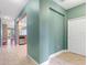 Hallway view showcasing tile floors, fresh green paint, white trim, and an open view of kitchen at 555 Presido Park Pl, Kissimmee, FL 34759