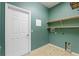 This laundry room has tile floors and wire shelving at 555 Presido Park Pl, Kissimmee, FL 34759