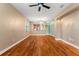 Spacious living room featuring hardwood floors, neutral walls and open access to the kitchen area at 555 Presido Park Pl, Kissimmee, FL 34759
