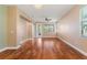 Spacious living room with hardwood floors, ceiling fan, and lots of natural light, perfect for entertaining at 555 Presido Park Pl, Kissimmee, FL 34759