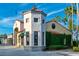 Picturesque street view of retail storefronts with stone accents and charming architecture lined with palm trees at 555 Presido Park Pl, Kissimmee, FL 34759