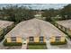 Aerial view of two houses with tile roofs, lush landscaping, and charming curb appeal at 635 Lake Marion Golf Resort, Kissimmee, FL 34759