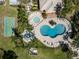 Aerial view of a pool, spa, shuffleboard court, and a clubhouse surrounded by tropical landscaping at 635 Lake Marion Golf Resort, Kissimmee, FL 34759
