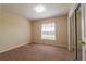 Carpeted bedroom with a window and a sliding mirror door closet at 635 Lake Marion Golf Resort, Kissimmee, FL 34759