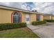 Charming single-story home featuring manicured front bushes and a welcoming walkway to the front door at 635 Lake Marion Golf Resort, Kissimmee, FL 34759