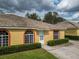 A sunny, single-story home featuring a tile roof and manicured landscaping at 635 Lake Marion Golf Resort, Kissimmee, FL 34759