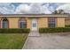 Charming single-story home featuring manicured front bushes and a welcoming walkway to the front door at 635 Lake Marion Golf Resort, Kissimmee, FL 34759