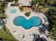 Aerial view of a community pool and spa, surrounded by lounge chairs and lush tropical landscaping at 635 Lake Marion Golf Resort, Kissimmee, FL 34759
