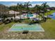 Aerial view of a shuffleboard court and community pool area, nestled amidst lush green surroundings at 635 Lake Marion Golf Resort, Kissimmee, FL 34759