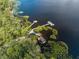 Overhead view of boat docks, wooden walkways, and a lake in a wooded community at 7128 Red Lantern Dr # 0, Harmony, FL 34773