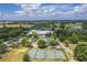 Aerial view of a community with a pool, tennis courts, and golf course at 7128 Red Lantern Dr # 0, Harmony, FL 34773