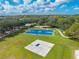 Aerial view of a basketball court and recreational area with picnic tables and walking paths at 7128 Red Lantern Dr # 0, Harmony, FL 34773