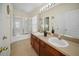 Bathroom featuring a double sink vanity and a shower with glass door at 7128 Red Lantern Dr # 0, Harmony, FL 34773