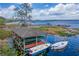 Aerial view of a boat dock with canoes and boats on a clear lake at 7128 Red Lantern Dr # 0, Harmony, FL 34773