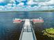 Aerial shot of a boat dock with two boats moored on a serene lake at 7128 Red Lantern Dr # 0, Harmony, FL 34773