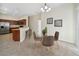 Cozy dining area with a modern glass table and stylish chairs, adjacent to the kitchen and living space at 7128 Red Lantern Dr # 0, Harmony, FL 34773