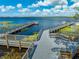 A high-angle view of a long wooden dock leading to a picturesque lake at 7128 Red Lantern Dr # 0, Harmony, FL 34773