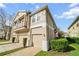 Exterior view of townhome showing balconies and garage at 7128 Red Lantern Dr # 0, Harmony, FL 34773