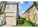 Exterior view of townhome showing garage and landscaping at 7128 Red Lantern Dr # 0, Harmony, FL 34773