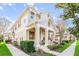 Charming townhome featuring a welcoming front porch, manicured landscaping, and classic architectural details at 7128 Red Lantern Dr # 0, Harmony, FL 34773