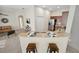Stylish kitchen with stainless steel appliances, a breakfast bar, and an open view to the living area at 7128 Red Lantern Dr # 0, Harmony, FL 34773