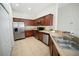 Well-equipped kitchen features stainless steel appliances, ample cabinet space, and tile flooring for easy maintenance at 7128 Red Lantern Dr # 0, Harmony, FL 34773