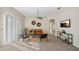 Comfortable living room with a leather sofa, stylish decor, and plenty of natural light from the sliding glass door at 7128 Red Lantern Dr # 0, Harmony, FL 34773