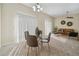 Bright and airy living area with a dining table and a view into the Gathering room, perfect for entertaining guests at 7128 Red Lantern Dr # 0, Harmony, FL 34773