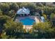 Aerial view of community pool and gazebo with lounge chairs in a wooded area at 7128 Red Lantern Dr # 0, Harmony, FL 34773