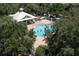 Aerial view of community pool and gazebo with people swimming and relaxing at 7128 Red Lantern Dr # 0, Harmony, FL 34773