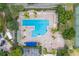 Aerial view of a community pool area with lounge chairs, umbrellas, and well-maintained landscaping at 7128 Red Lantern Dr # 0, Harmony, FL 34773