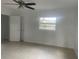 Bright and airy bedroom with tile flooring, a ceiling fan, and a view of the outdoors at 736 Nw 31St Ct, Winter Haven, FL 33881